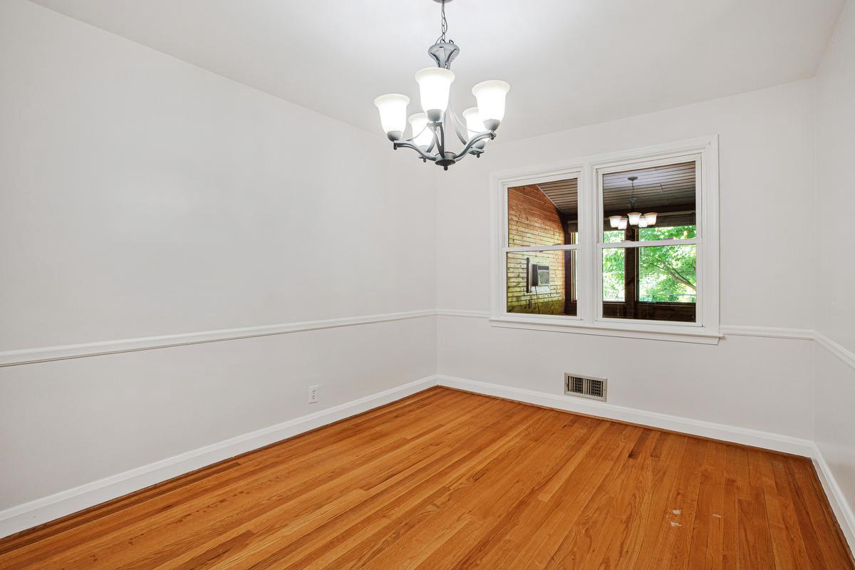 1016 Winsford Road Towson, MD 21204 - Photo 8 of 42 a view of an empty room with wooden floor and a window