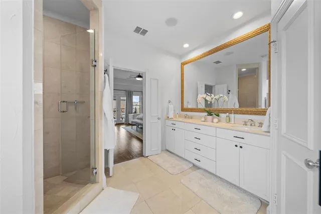 a bathroom with a granite countertop sink mirror and shower