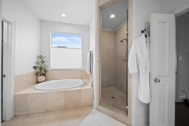a bathroom with a tub shower vanity and a sink