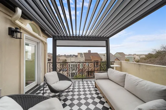 a balcony with furniture and a floor to ceiling window