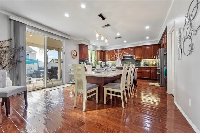 a large kitchen with a table and chairs