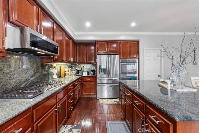a kitchen with granite countertop a sink and a stove