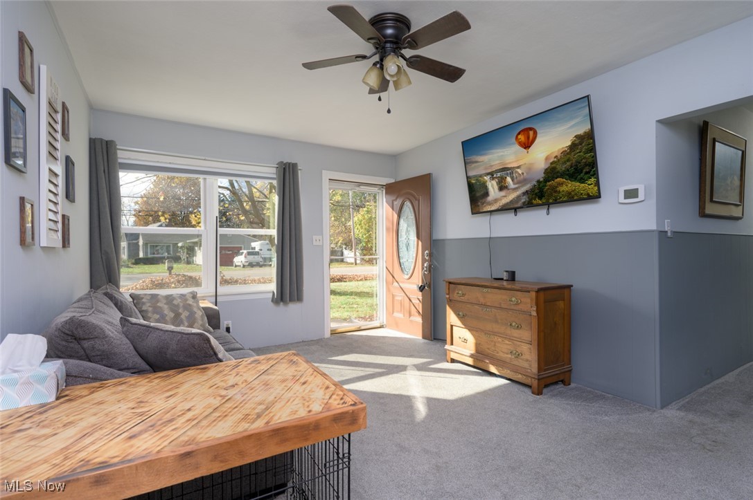 2547 Mogadore Road Akron, OH 44312 - Photo 7 of 31 Living area with light carpet and ceiling fan