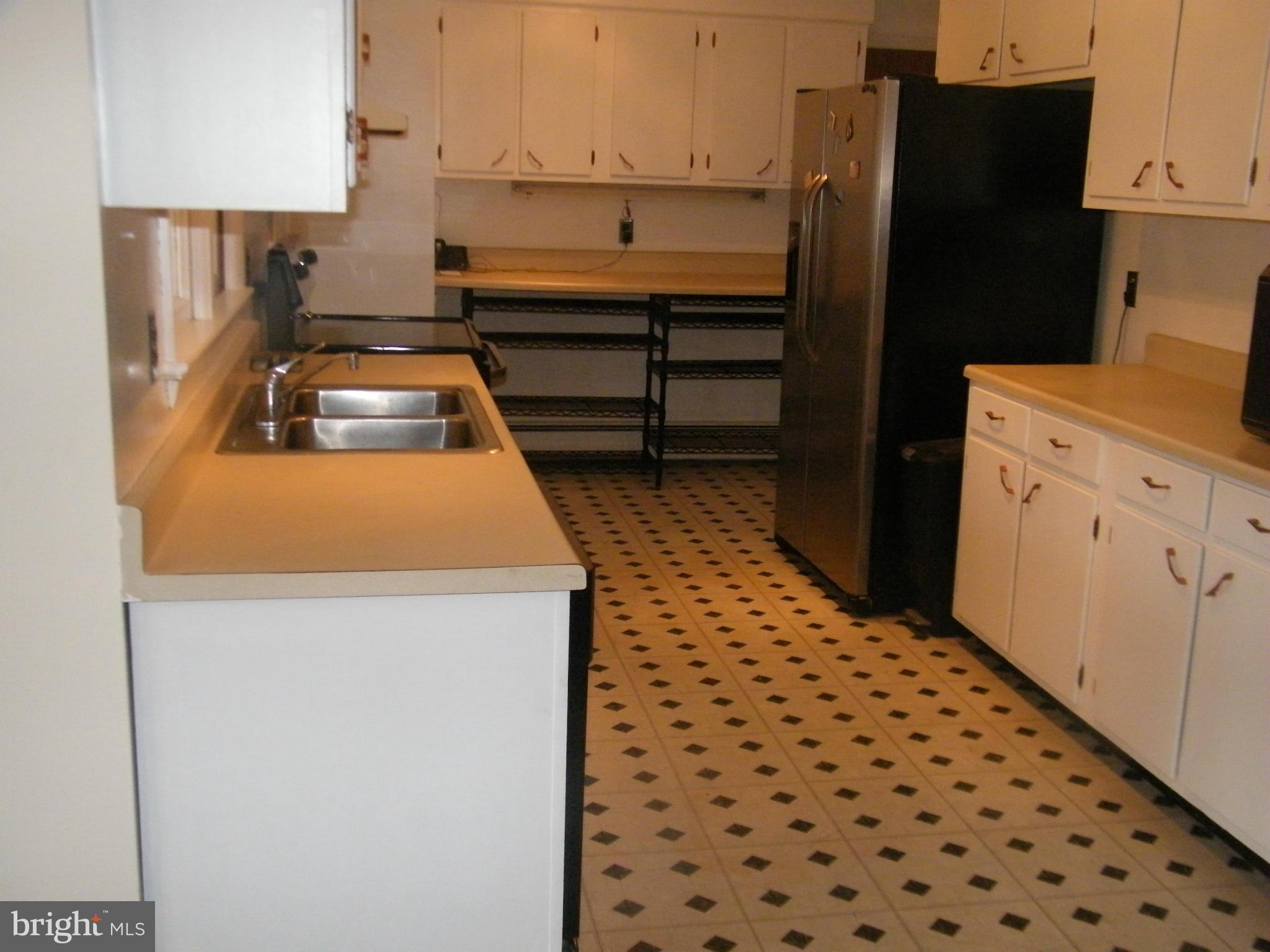 1100 Apple Valley Road Accokeek, MD 20607 - Photo 8 of 30 a kitchen with a refrigerator and a stove