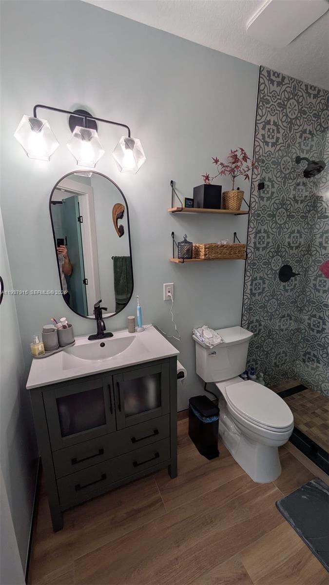 12293 Southwest 123rd Terrace Miami, FL 33186 - Photo 14 of 30 a bathroom with a toilet a sink and mirror