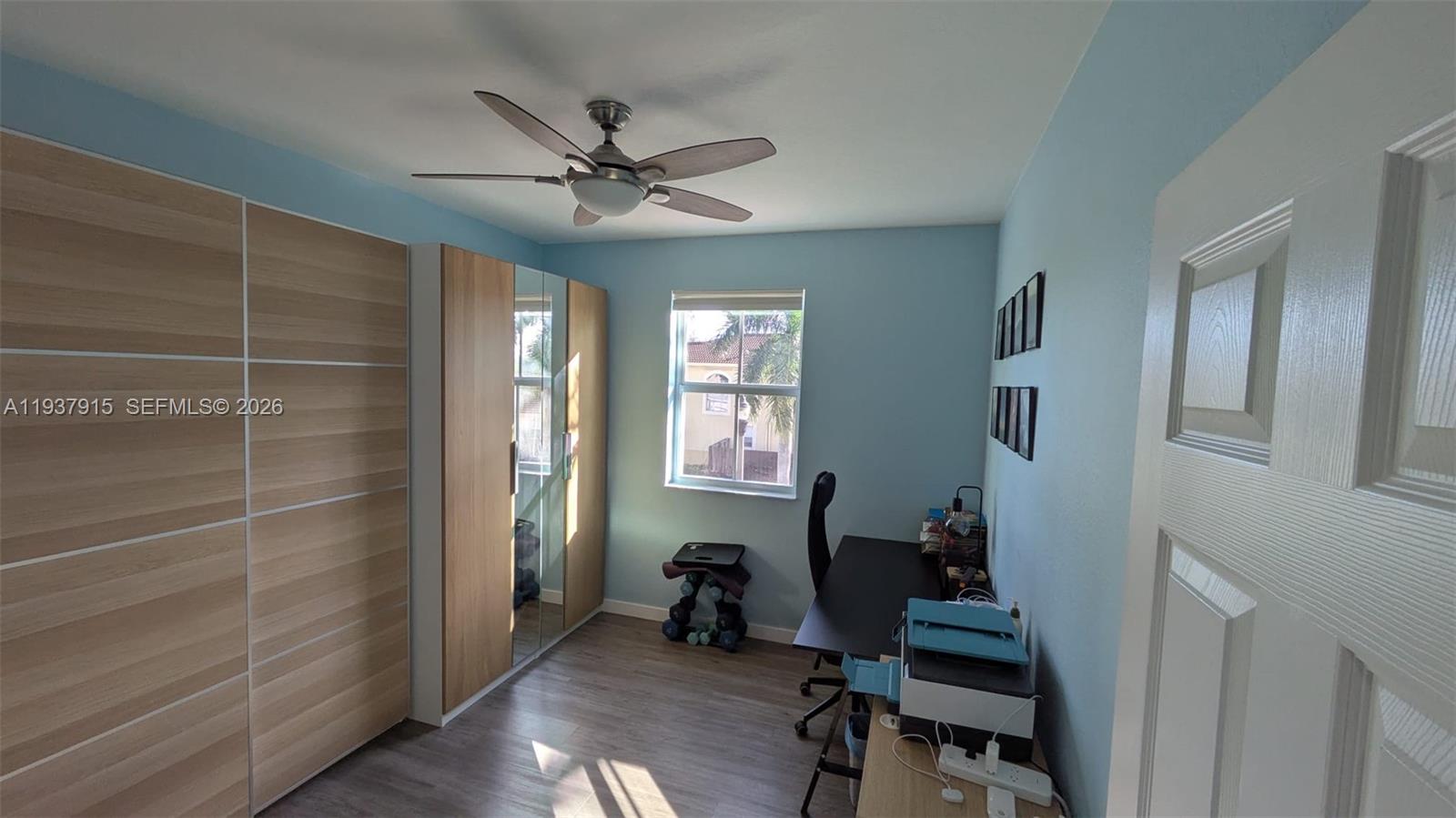 12293 Southwest 123rd Terrace Miami, FL 33186 - Photo 15 of 30 a view of a workspace with wooden floor and a window