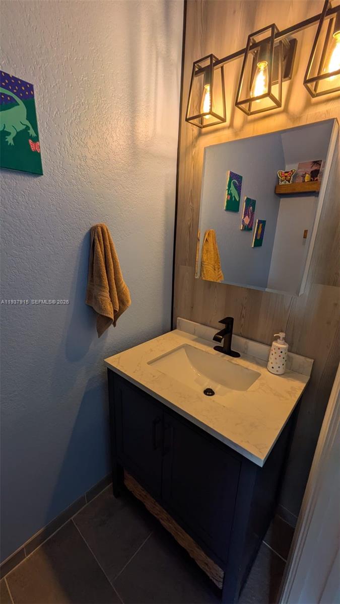 12293 Southwest 123rd Terrace Miami, FL 33186 - Photo 17 of 30 a bathroom with a sink and a mirror