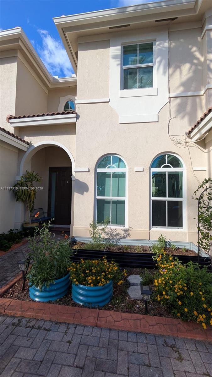 12293 Southwest 123rd Terrace Miami, FL 33186 - Photo 2 of 30 a front view of a house with garden