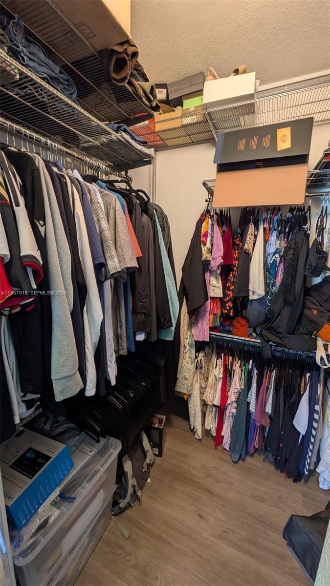 12293 Southwest 123rd Terrace Miami, FL 33186 - Photo 21 of 30 a view of walk in closet with clothes and shoes