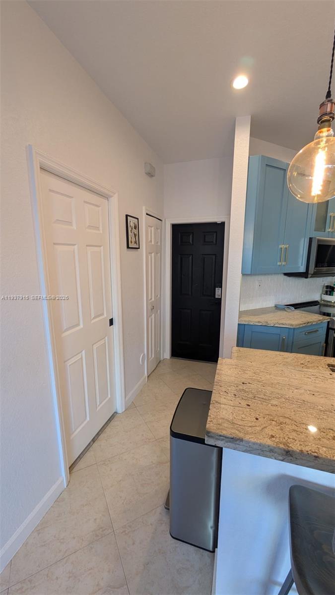 12293 Southwest 123rd Terrace Miami, FL 33186 - Photo 23 of 30 a living room with stainless steel appliances granite countertop furniture and a fireplace