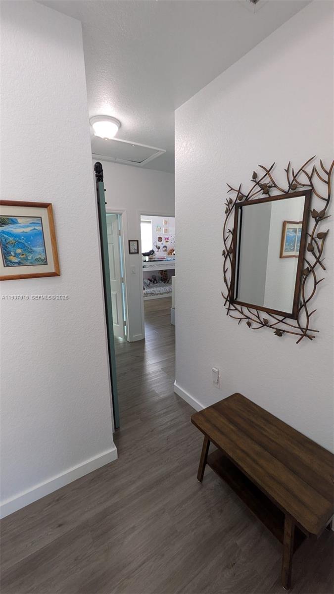 12293 Southwest 123rd Terrace Miami, FL 33186 - Photo 25 of 30 a room with wooden floor and gym equipment