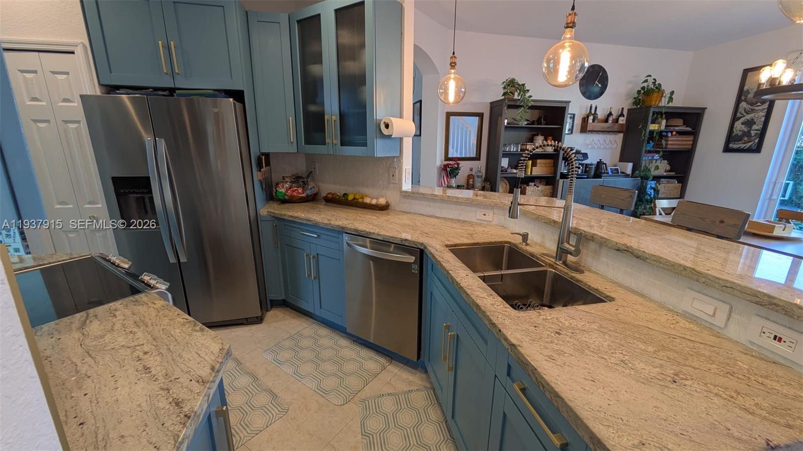 12293 Southwest 123rd Terrace Miami, FL 33186 - Photo 4 of 30 a kitchen with stainless steel appliances granite countertop a sink stove and refrigerator