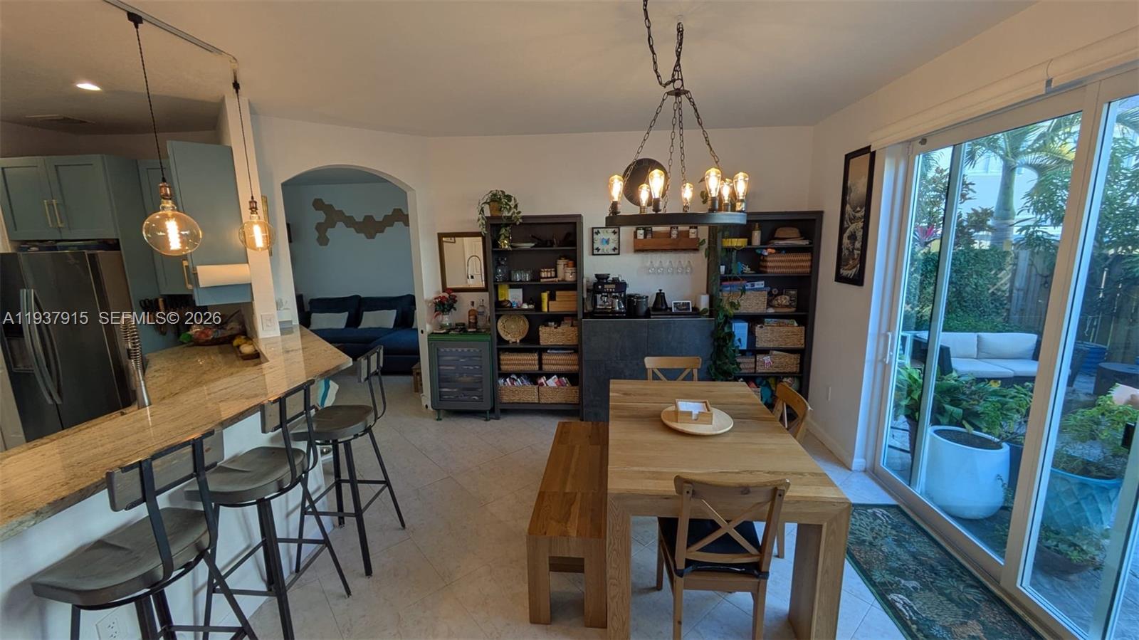 12293 Southwest 123rd Terrace Miami, FL 33186 - Photo 6 of 30 a dining room with furniture a chandelier and wooden floor