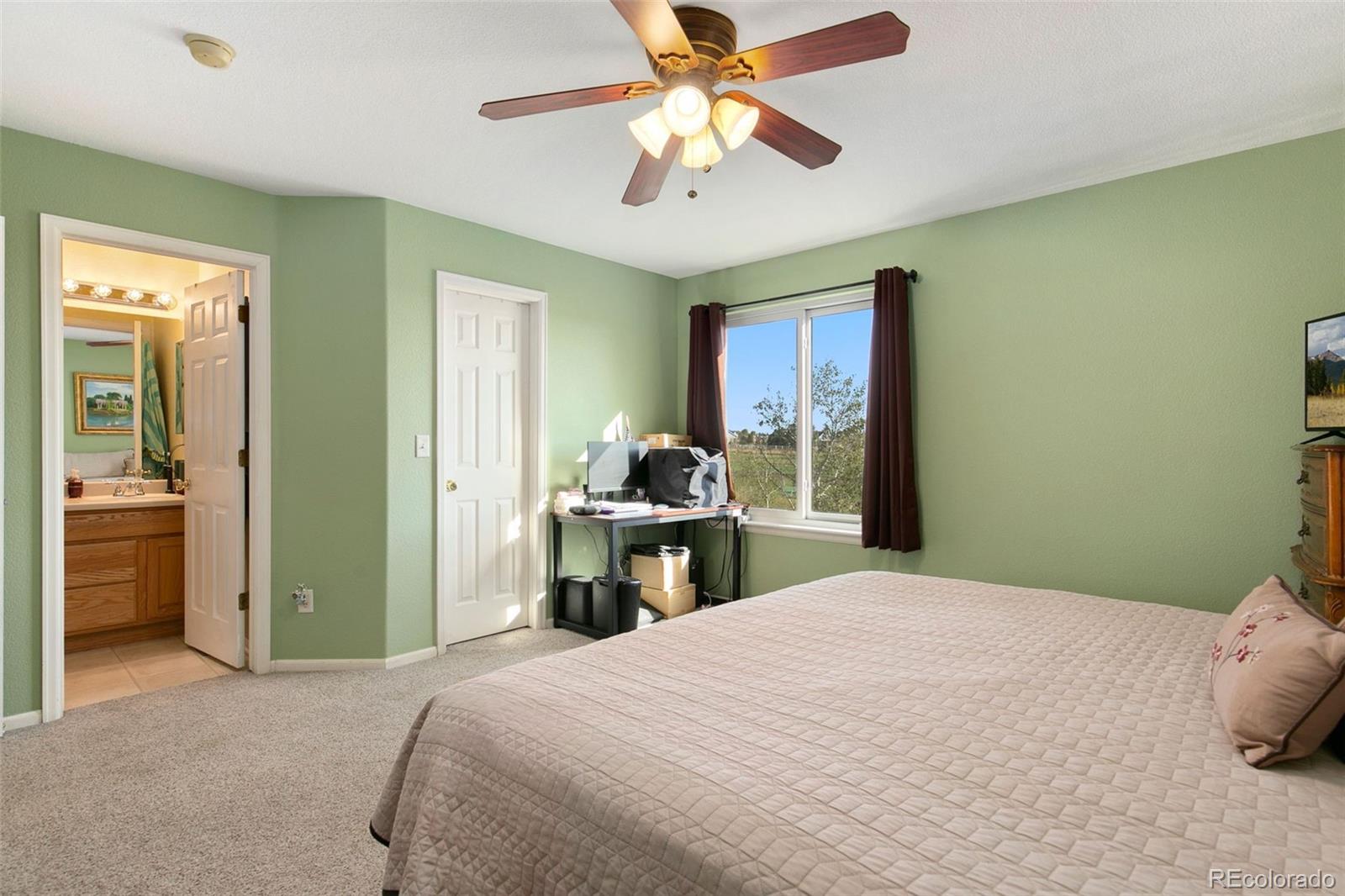 1606 Conestoga Drive Fort Lupton, CO 80621 - Photo 13 of 25 a bedroom with a bed and a chandelier