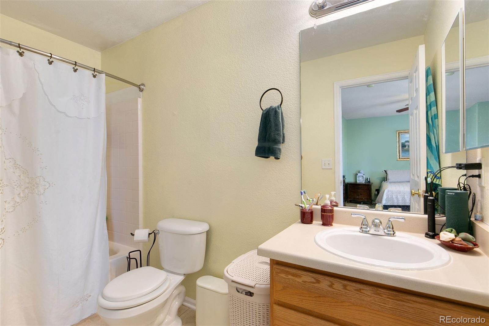 1606 Conestoga Drive Fort Lupton, CO 80621 - Photo 14 of 25 a bathroom with a sink a toilet and shower