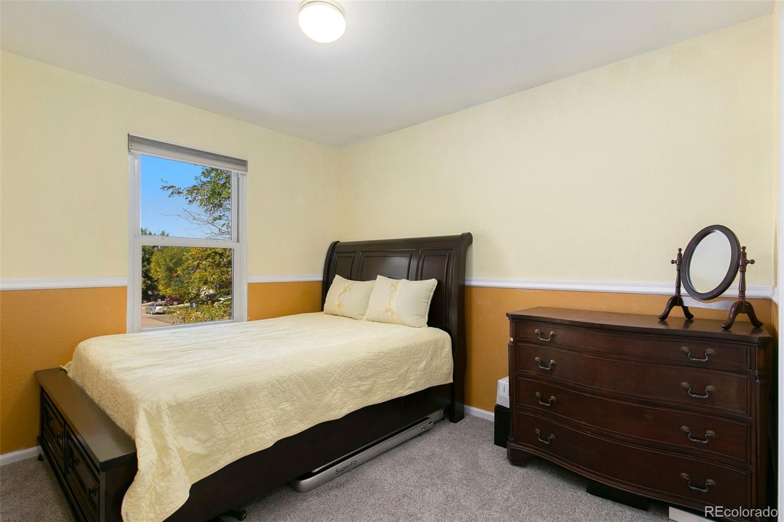 1606 Conestoga Drive Fort Lupton, CO 80621 - Photo 15 of 25 a bedroom with a bed and a dresser