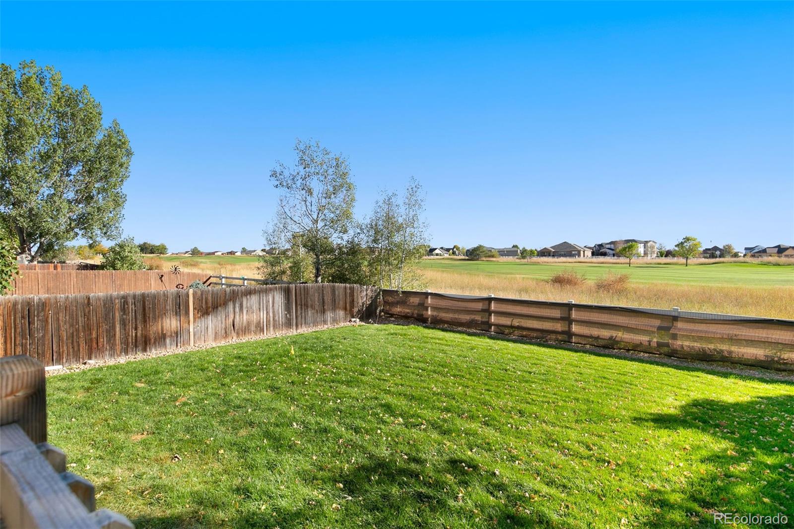 1606 Conestoga Drive Fort Lupton, CO 80621 - Photo 19 of 25 a view of a lake with houses in the back