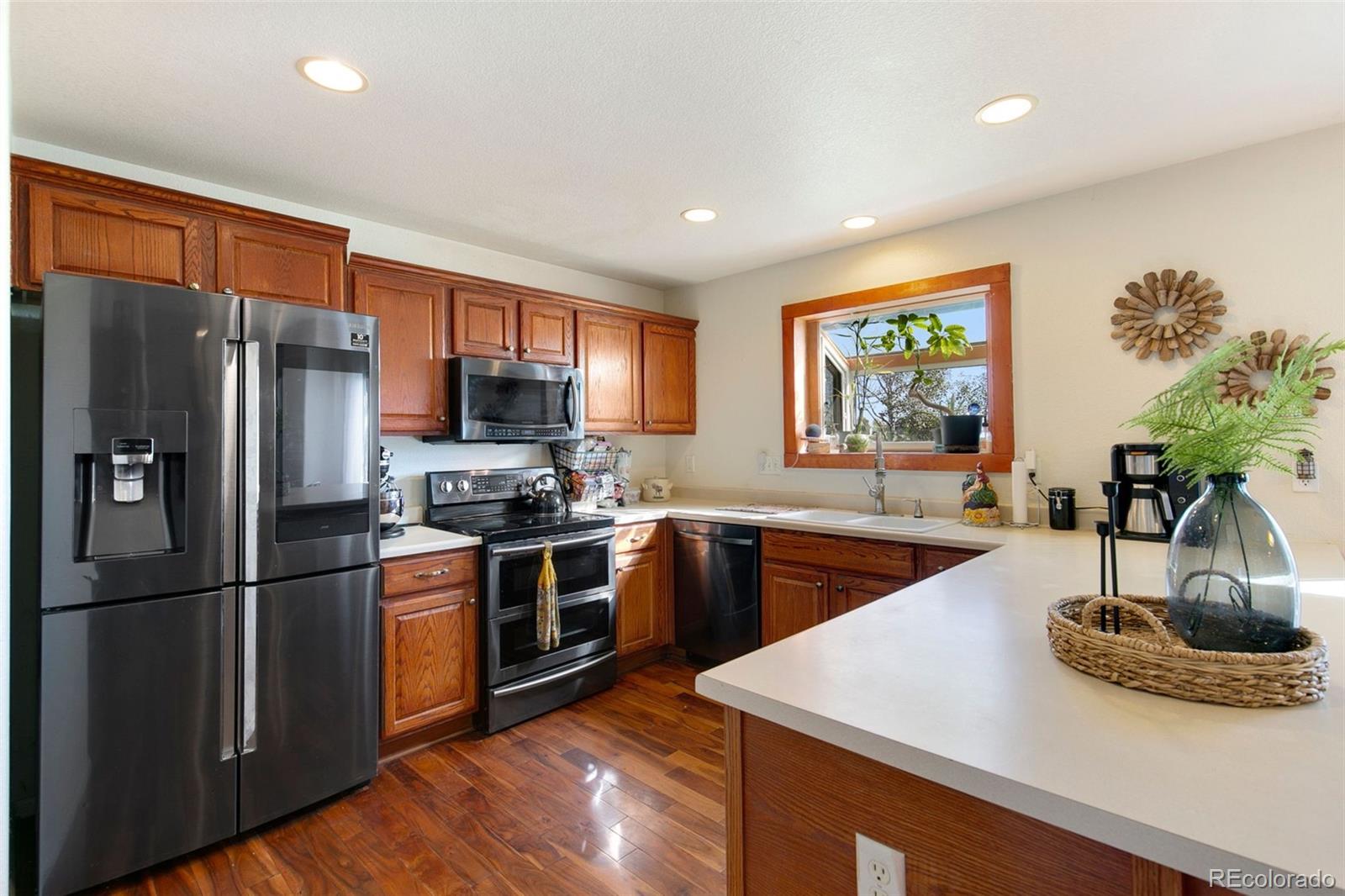 1606 Conestoga Drive Fort Lupton, CO 80621 - Photo 2 of 25 a kitchen with stainless steel appliances granite countertop a refrigerator a sink dishwasher a stove and a refrigerator