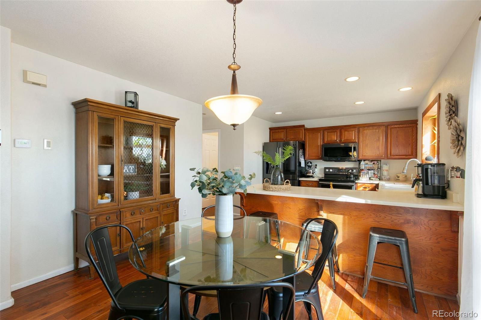 1606 Conestoga Drive Fort Lupton, CO 80621 - Photo 8 of 25 a view of a dining room with furniture window and wooden floor