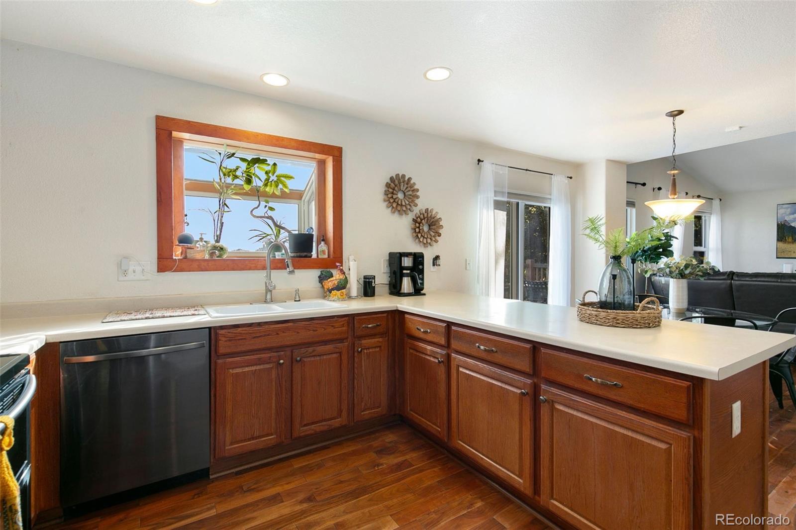 1606 Conestoga Drive Fort Lupton, CO 80621 - Photo 9 of 25 a view of a kitchen counter top space sink and wooden floor