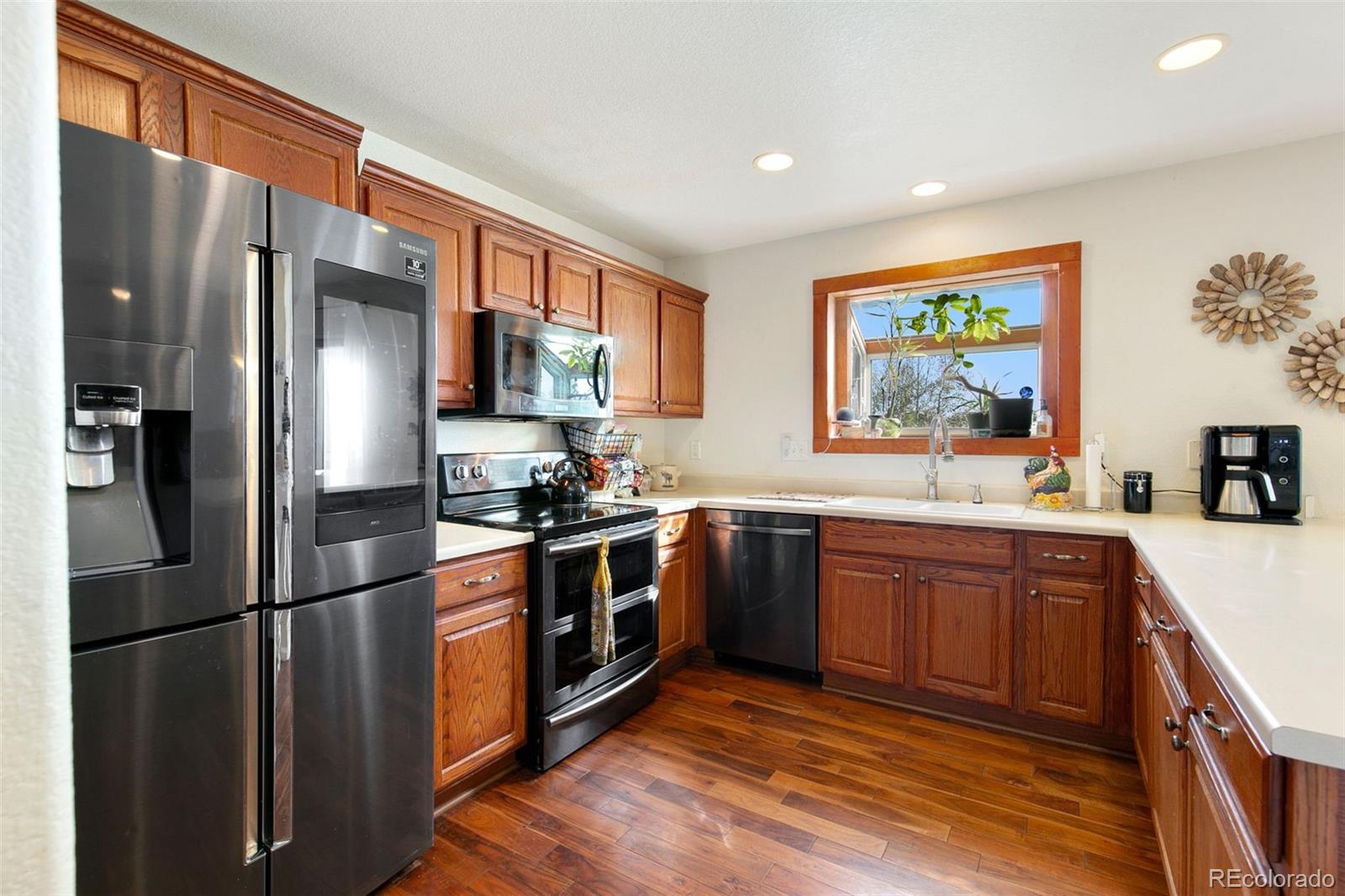 1606 Conestoga Drive Fort Lupton, CO 80621 - Photo 10 of 25 a kitchen with stainless steel appliances granite countertop a refrigerator stove and sink