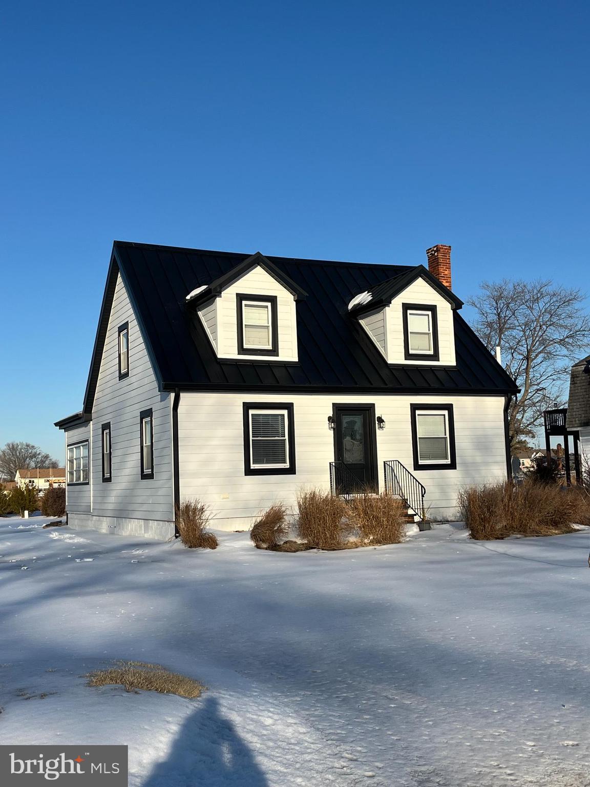21560 Chicken Point Road Tilghman, MD 21671 - Photo 1 of 25 a front view of a house with a yard