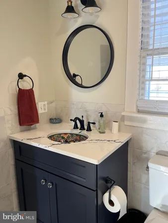 a bathroom with a toilet a sink and a mirror