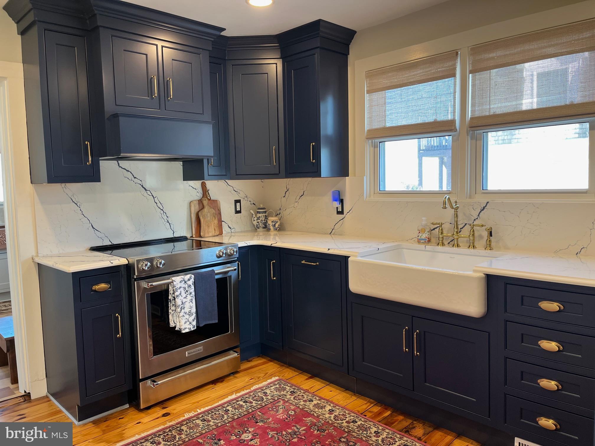21560 Chicken Point Road Tilghman, MD 21671 - Photo 6 of 25 a kitchen with a sink stove and cabinets