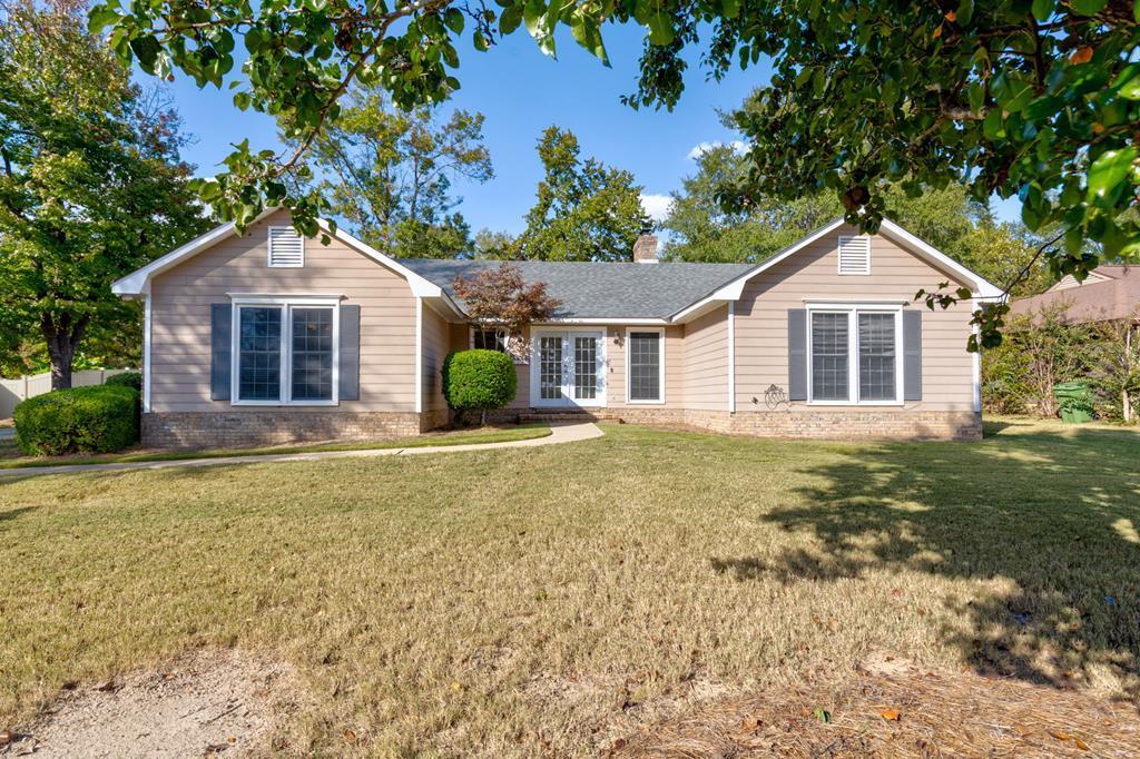 a big house with a big yard and large trees