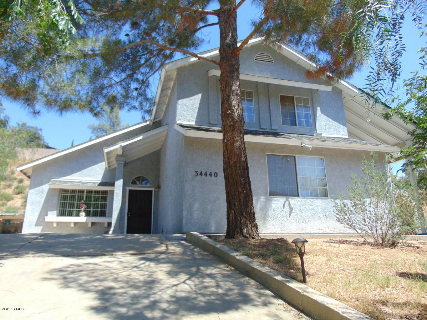34440 Red Rover Mine Road Acton, CA 93510 - Photo 1 of 39 a front view of a house with a yard and garage
