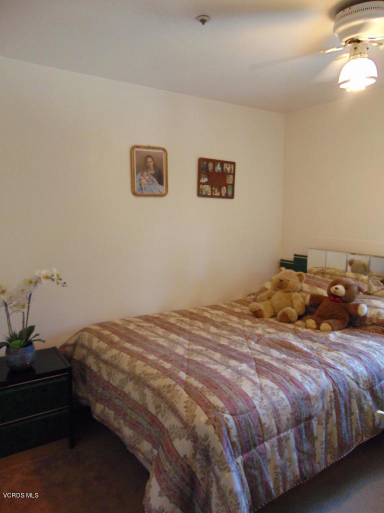 34440 Red Rover Mine Road Acton, CA 93510 - Photo 23 of 39 a bedroom with a bed and a lamp on table