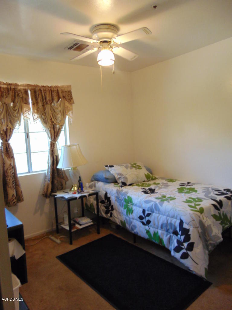 34440 Red Rover Mine Road Acton, CA 93510 - Photo 24 of 39 a bedroom with a bed and a chandelier