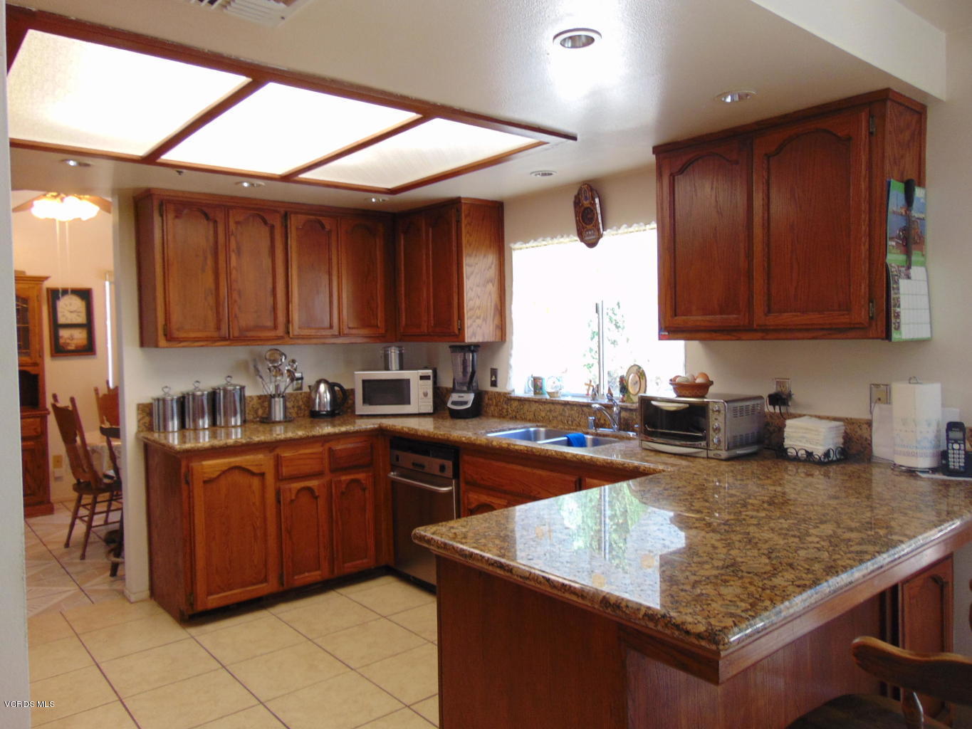34440 Red Rover Mine Road Acton, CA 93510 - Photo 4 of 39 a kitchen with wooden cabinets a sink and a stove