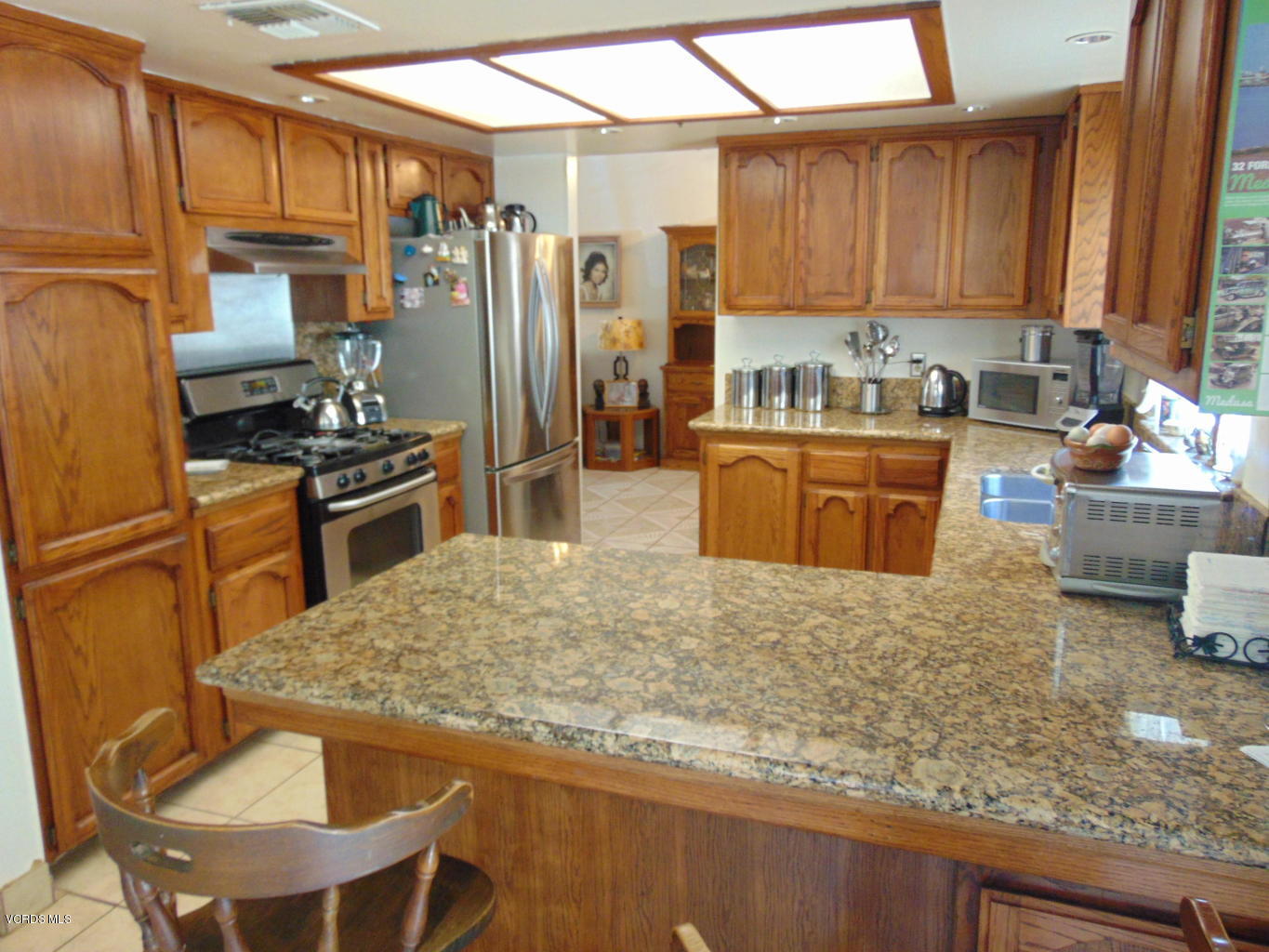 34440 Red Rover Mine Road Acton, CA 93510 - Photo 6 of 39 a kitchen with stainless steel appliances granite countertop a refrigerator stove microwave and sink
