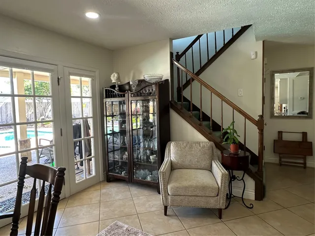 a dining room with furniture and stairs