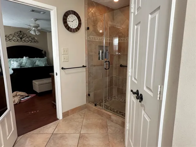 a bathroom with a toilet and a shower