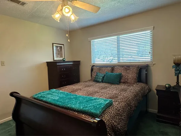 a bedroom with a bed and a dresser