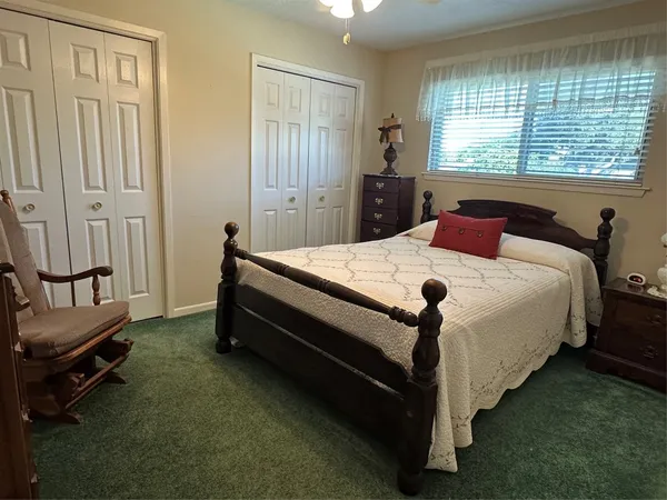 a bed room with a bed and a window