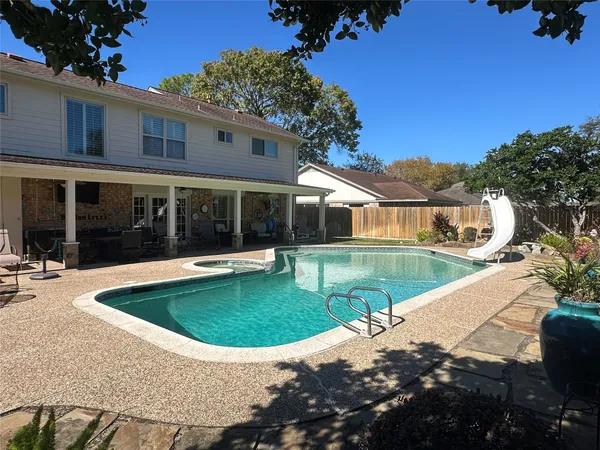 a view of house with swimming pool outdoor seating