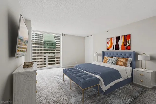 a bedroom with a bed and a flat screen tv