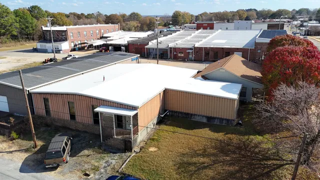 a aerial view of a house with cars parked