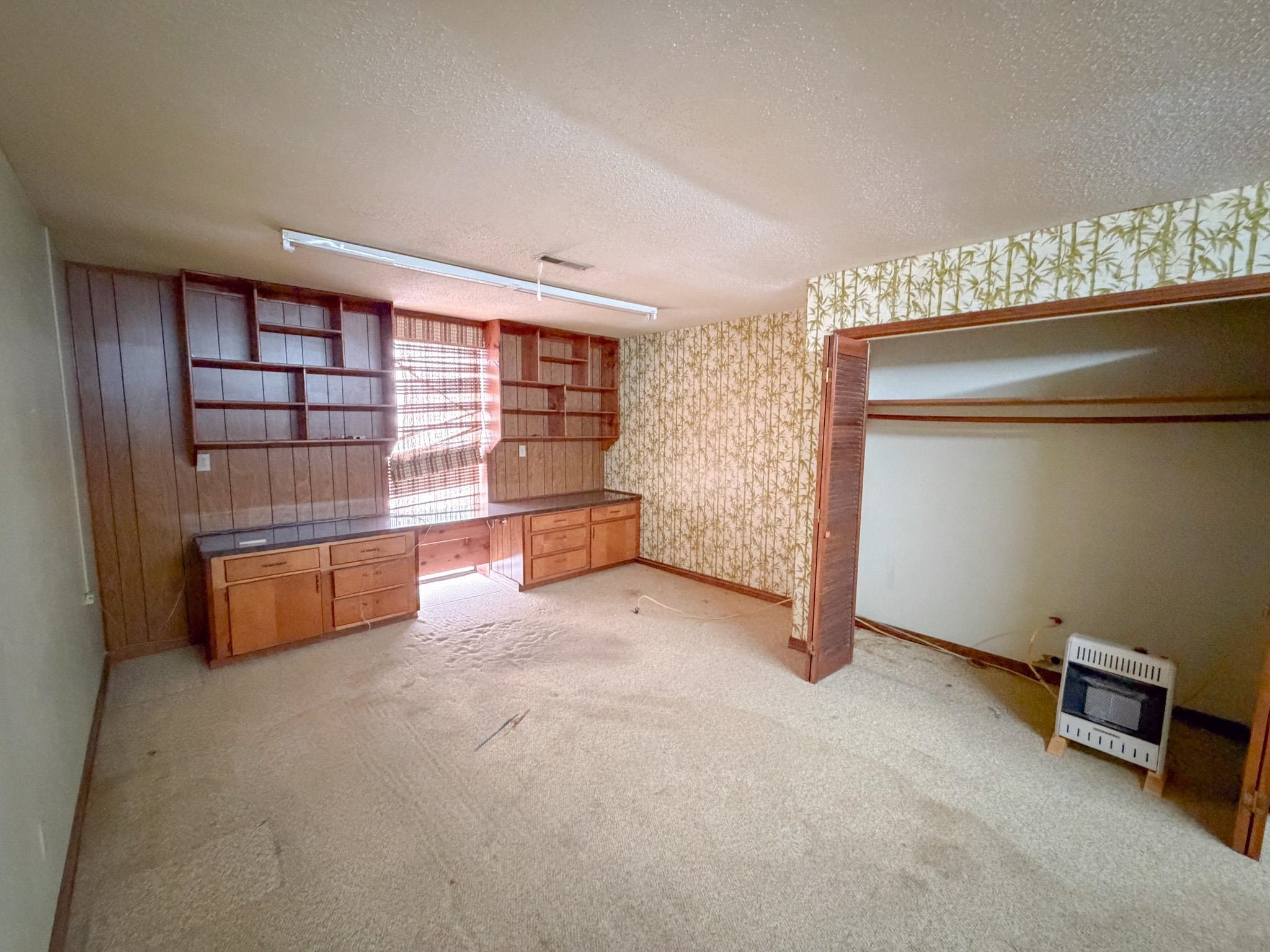 376 2nd Street Belmont, MS 38827 - Photo 27 of 29 an empty room with a fireplace and painted walls