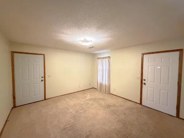 an empty room with a empty space and windows
