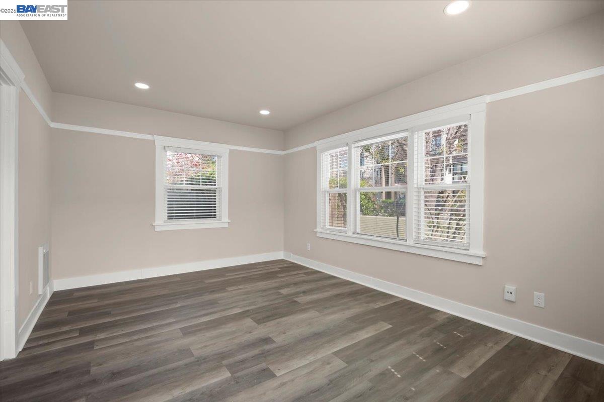 1504 Tenth Street Berkeley, CA 94710 - Photo 6 of 12 a view of an empty room with wooden floor and a window