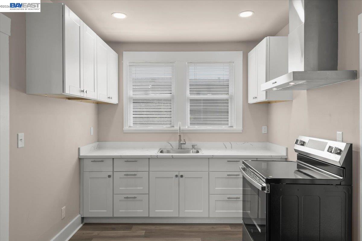 1504 Tenth Street Berkeley, CA 94710 - Photo 7 of 12 a kitchen with a sink cabinets and window