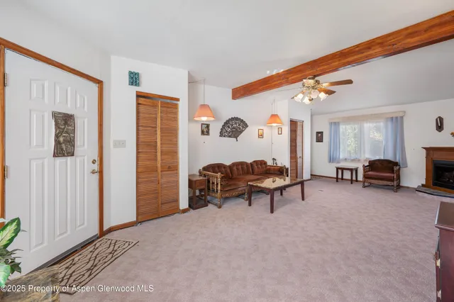 a view of a livingroom with furniture and a window