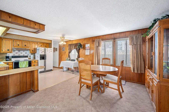 a dining room with furniture and large window