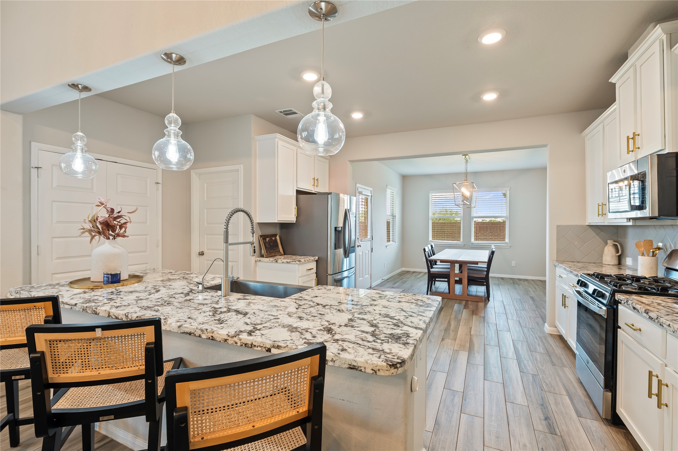 7802 Bellwick Court Pasadena, TX 77505 - Photo 13 of 37 a kitchen with kitchen island granite countertop a sink cabinets and stainless steel appliances