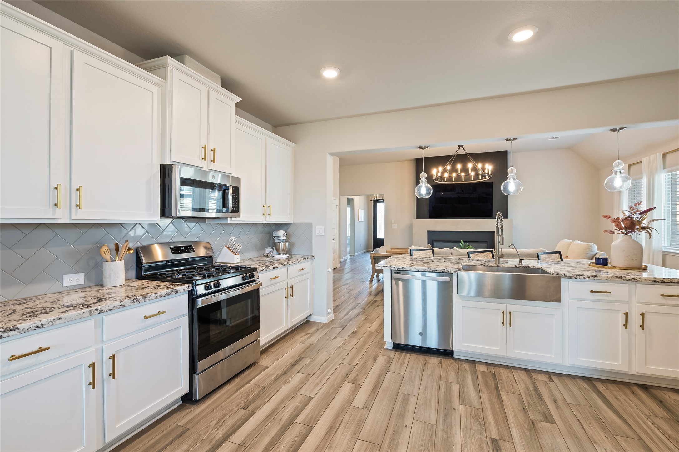 7802 Bellwick Court Pasadena, TX 77505 - Photo 14 of 37 a large kitchen with stainless steel appliances granite countertop a stove oven and a white cabinets