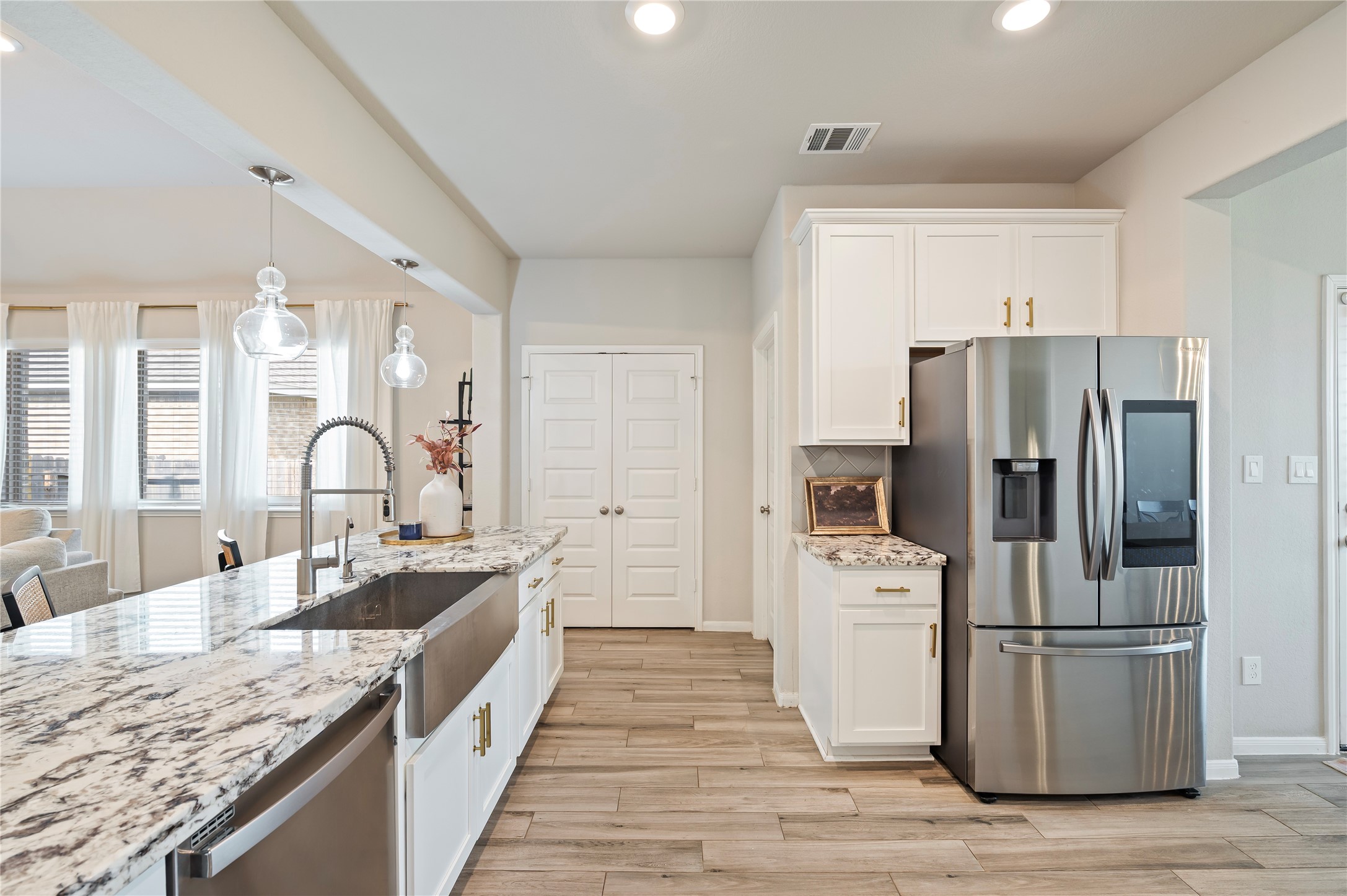 7802 Bellwick Court Pasadena, TX 77505 - Photo 16 of 37 a large kitchen with stainless steel appliances granite countertop a refrigerator a stove and a sink with wooden floors